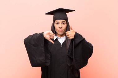 Genç Latin kız öğrenci kafası karışık, bilgisiz ve kararsız hissediyor, iyi ve kötü seçenekleri farklı seçeneklerle tartıyor.