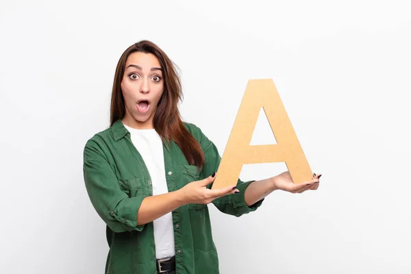 Young Pretty Woman Surprised Shocked Amazed Holding Letter Alphabet Form — Stock Photo, Image