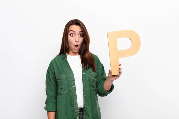 Young Pretty Woman Surprised Shocked Amazed Holding Letter Alphabet Form — Stock Photo, Image