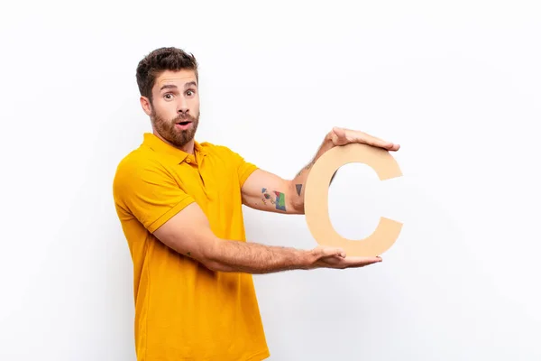 Young Handsome Man Surprised Shocked Amazed Holding Letter Alphabet Form — Stock Photo, Image