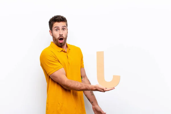 Young Handsome Man Surprised Shocked Amazed Holding Letter Alphabet Form — Stock Photo, Image