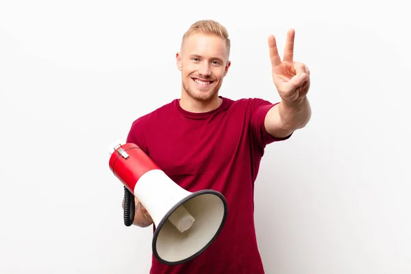 Young Blonde Man Smiling Looking Happy Carefree Positive Gesturing Victory — Stock Photo, Image
