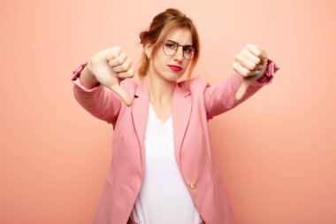 Genç, güzel, sarışın bir kadın üzgün, hayal kırıklığına uğramış ya da kızgın görünüyor, anlaşmazlık içinde parmaklarını gösteriyor, hayal kırıklığına uğramış hissediyor. iş kavramı