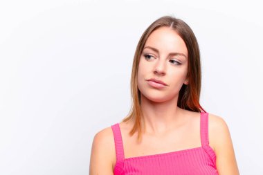 Kızıl saçlı güzel kadın merak ediyor, mutlu düşünceler ve fikirler düşünüyor, hayal kuruyor, kenarda yer arıyor.