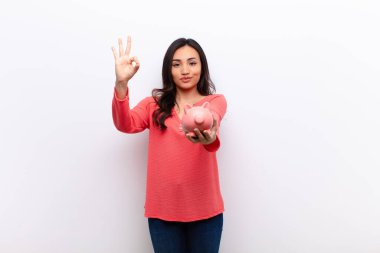 Genç, Latin, güzel bir kadın. Düz duvara yaslanmış, kumbaralı.