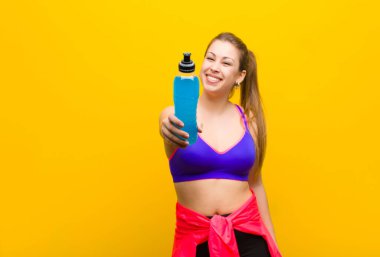 Enerji içeceği olan genç sarışın kadın. spor konsepti