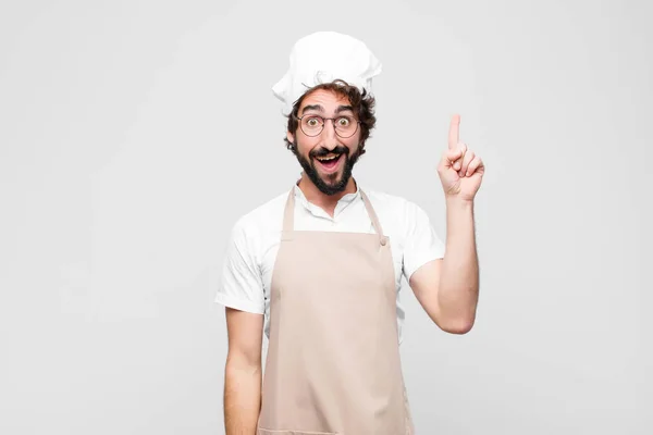 Young Crazy Chef Smiling Cheerfully Happily Pointing Upwards One Hand — Stock Photo, Image