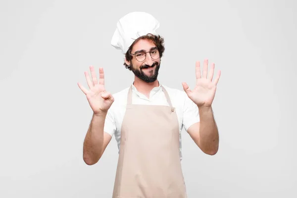 Joven Chef Loco Sonriendo Buscando Amigable Mostrando Número Nueve Noveno — Foto de Stock