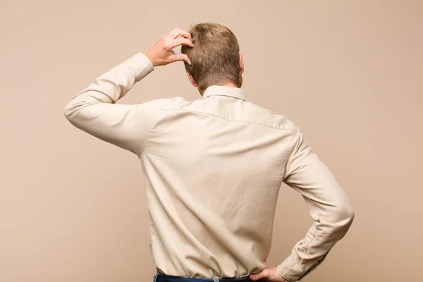 Young Blonde Man Feeling Clueless Confused Thinking Solution Hand Hip — Stock Photo, Image