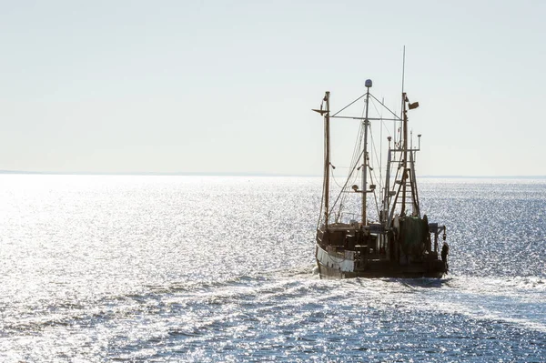 Trawler Seven Seas heading into the light — Stock Image Trawler Seven Seas heading into the light Stock Photo