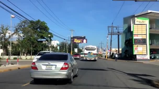 Pohled do auta projíždějící ulicí Francisco de Macorís, Dominikánská republika. — Stock video
