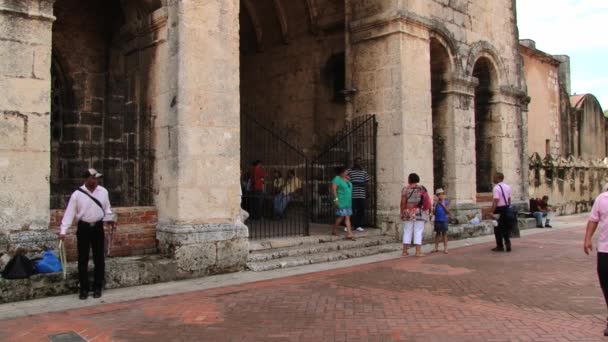 Mensen lopen voor de kathedraal in Santo Domingo, Dominicaanse Republiek. — Stockvideo
