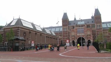 İnsanlar Bisiklet Rijksmuseum Amsterdam, Hollanda bina önünde binmek. 