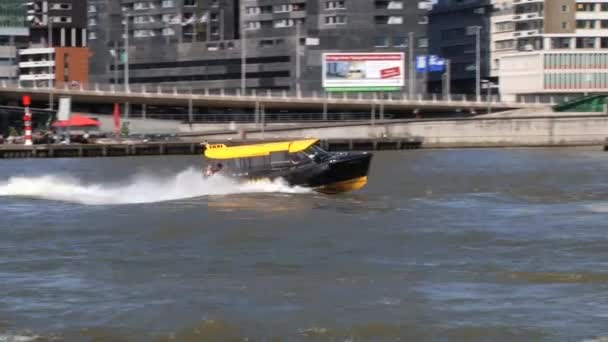 Water taxi boat pass by the Maas river in Rotterdam, Netherlands. — Stock Video
