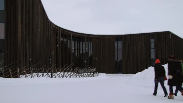 Les gens approchent Saami Bâtiment du centre culturel à Inari, Finlande . — Video