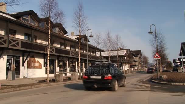 Cars pass by the street of the ski resort town of Hemsedal, Norway. — Stock Video
