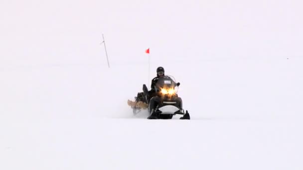 Homem monta snowmobile no assentamento ártico de Longyearbyen, Noruega . — Vídeo de Stock