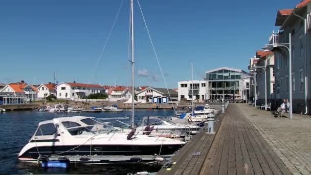 View to the buildings at the sea side street in the town of Smogen, Sweden. — Stock Video