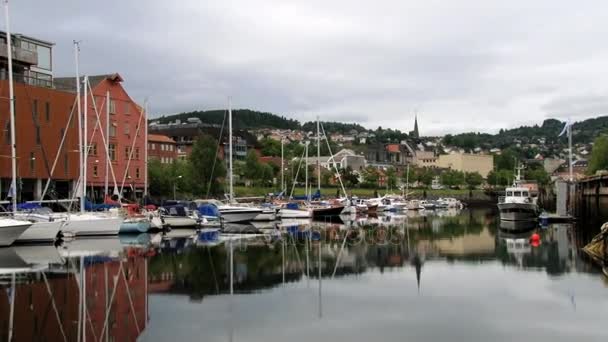 View to the city and boats tied at the harbor in Trondheim, Norway. — Stock Video