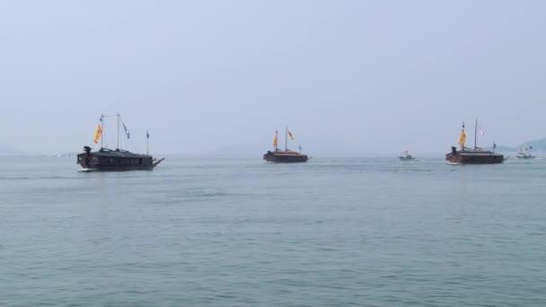 Replicas of the Korean Turtle warship sail by the sea Hansan festival in Tongyeong, Korea. — Stock Video