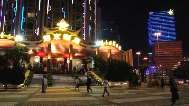 People walk by the street at night in Macau, China. — Stock Video