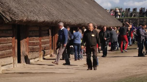 Människor besöker replika av järnåldern som berikade bosättningen i Biskupin, Polen. — Stockvideo