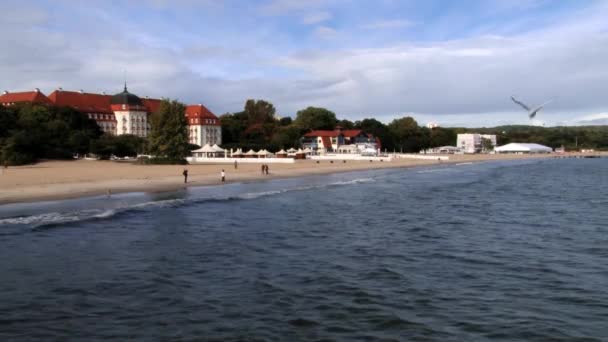 People walk by the seaside in Sopot, Poland. — Stock Video