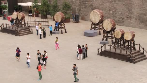 Menschen gehen am Platz vorbei und besuchen die große Mauer in Xian, China. — Stockvideo