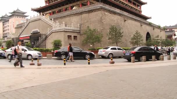 People walk in front of the Drum tower in Xian, China. — Stock Video