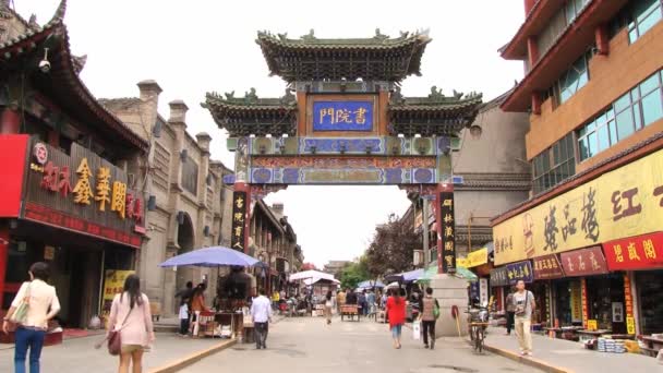 People walk by the shopping street in Xian, China. — Stock Video