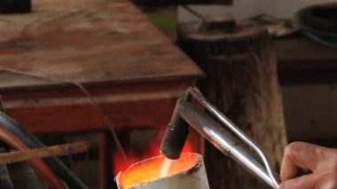 Surin, Thailand içinde Yakılan gaz ile pota gümüş adam erir.