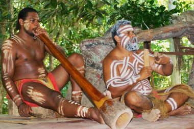 Aborigine actors perform music with traditional instruments in the Tjapukai Culture Park in Kuranda, Queensland, Australia. clipart