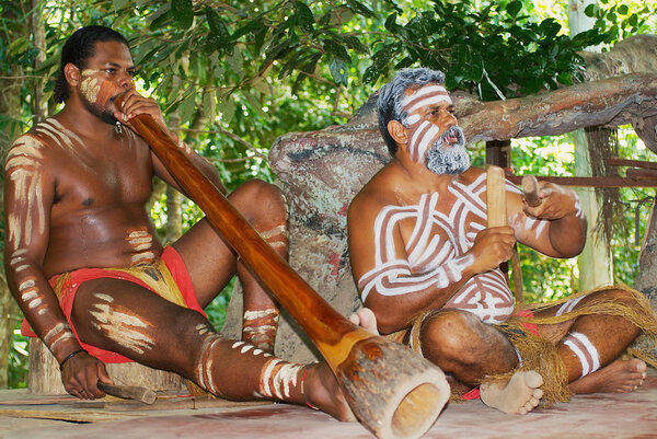 Aborigine actors perform music with traditional instruments in the Tjapukai Culture Park in Kuranda, Queensland, Australia.