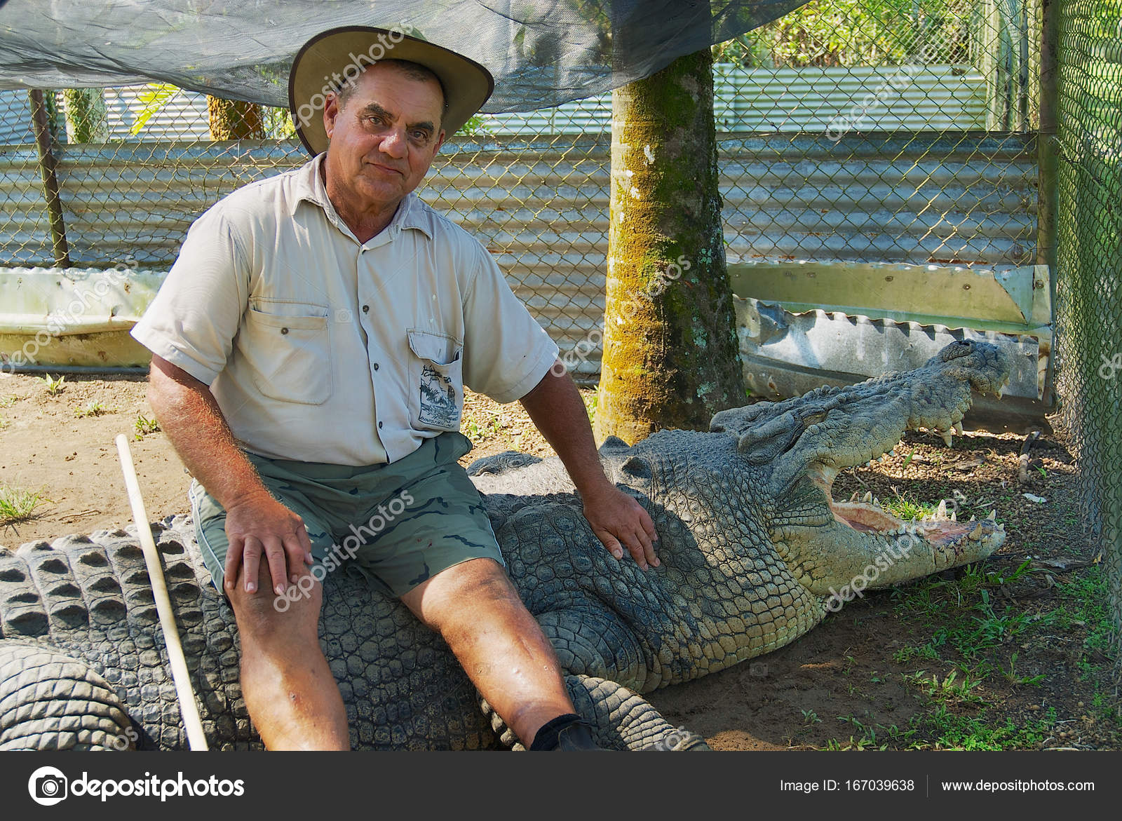 Crocodile farmer Mick Tabone sits on the biggest monster reptile
