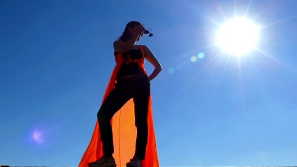 Beautiful Model Standing in the Sun Lights and Puts on Sunglasses in Slow Motion. — Stock Video