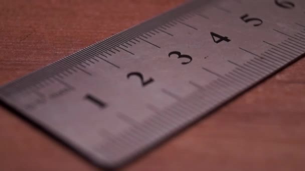 One Silver Ruler on a Table.slow Focusing. — Stock Video