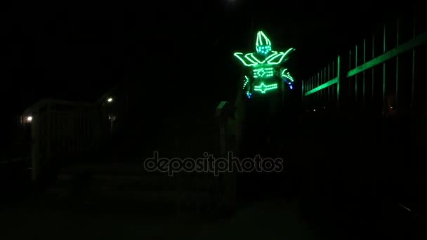 A Clown on Stilts at a Railway Station at Night. — Stock Video