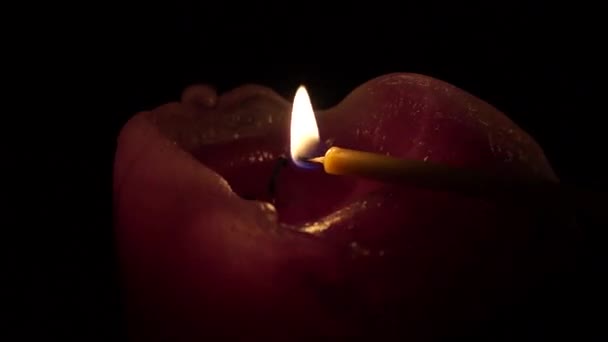 One Big Candle Lit With a Thin Candle. — Stock Video