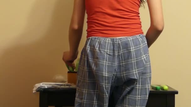 Ass of the Girl in Pajama Pants Standing Near the Table. — Stock Video