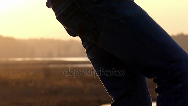 Young Man 'Legs ar Shot in the Field, When he is Dancing With a Nice Sunset Rays in the Backgroung in Slow Motion — стоковое видео