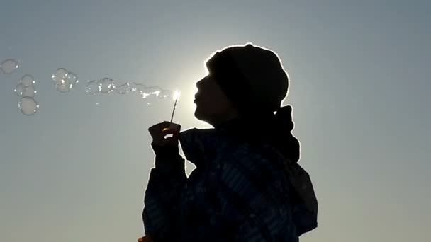 Silhouette of Little Boy in Slow Motion Blow Bubbles Into the Air. — Stock Video