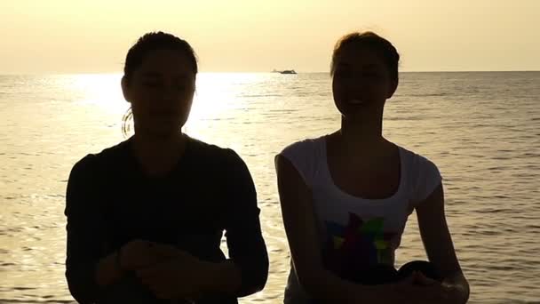 Two Young Women on a Seacoast Doing High Five in Slow Motion. — Stock Video