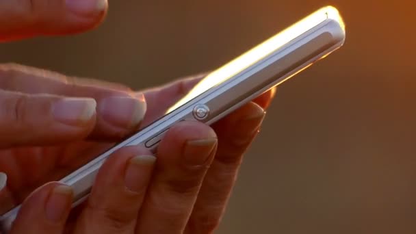 Female Hands Closeup Use a Smartphone, Flipping Through Information on the Touch Screen. — Stock Video