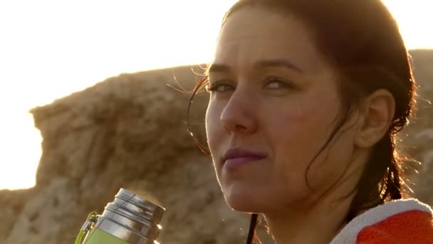 Smiling Girl Drinks Tea From a Thermos Flask on a Searesort in Egypt in Summer — Stock Video