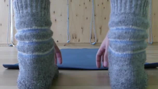 Young Man Rolls up a Yoga Mat in a Fitness Gym — Stock Video