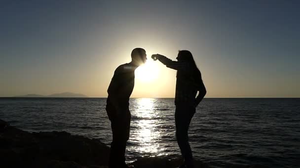 Couple in Live Frolick With Each Other on a Seacoast at Sunset in Slo-Mo — Stock Video