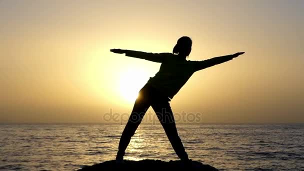 Giovane donna fa un Asana Yoga, piegando a destra, su un pittoresco Seashore a un tramonto meraviglioso — Video Stock