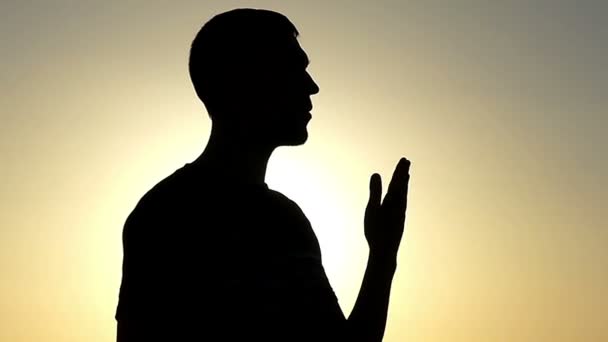 Young Man Makes Air Kiss Gesture While Standing in Profile at Sunset in Slo-Mo — Stok Video