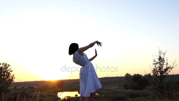 Cheery Woman Does Waving Movements With Her Hands at a Splendid Sunset in Slo-Mo — Stock Video