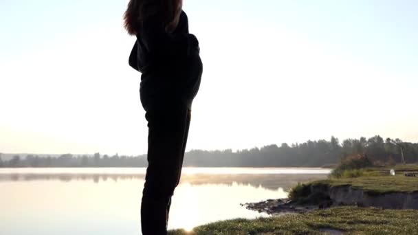 Een romantische zwangere vrouw speelt met Baby's Slippers bij zonsondergang in de herfst — Stockvideo